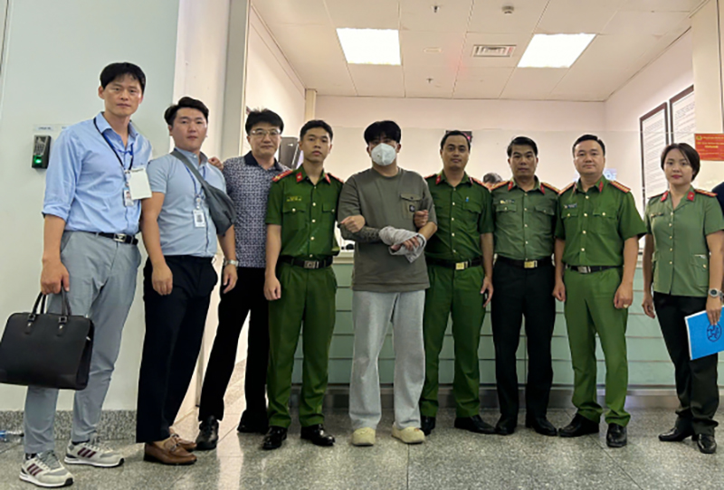 Công an quận Đống Đa bàn giao nghi phạm cho Cơ quan Cảnh sát Quốc gia Hàn Quốc. Ảnh: CAND