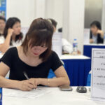 Bà Vân ghi lại thông tin ứng viên tiếng Hàn trong phiên tuyển dụng tại Hà Nội hồi tháng 11. Ảnh: Hồng Chiêu